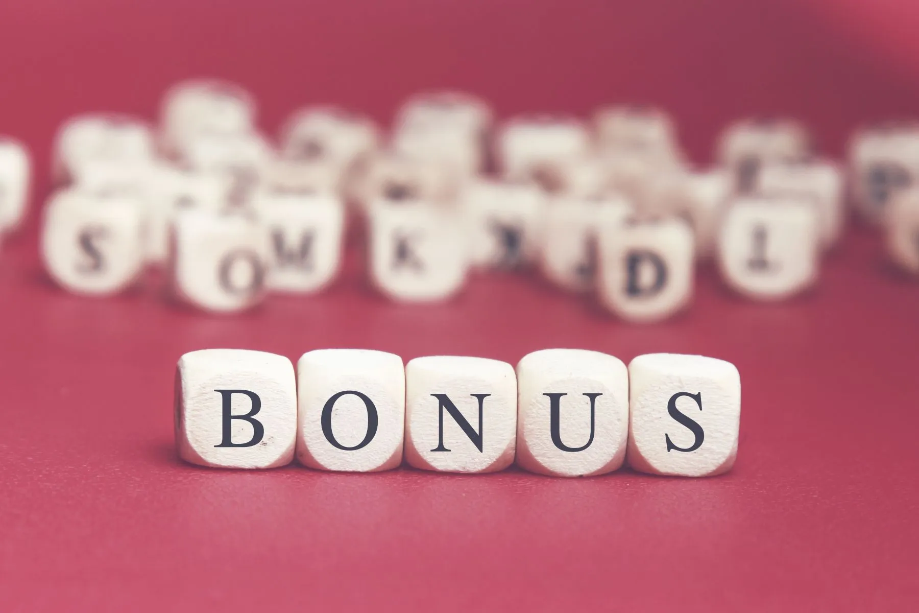 Buchstaben auf Würfeln, die das Wort "Bonus" als Zeichen für den Sportwetten Bonus der Wettanbieter Schweiz bilden